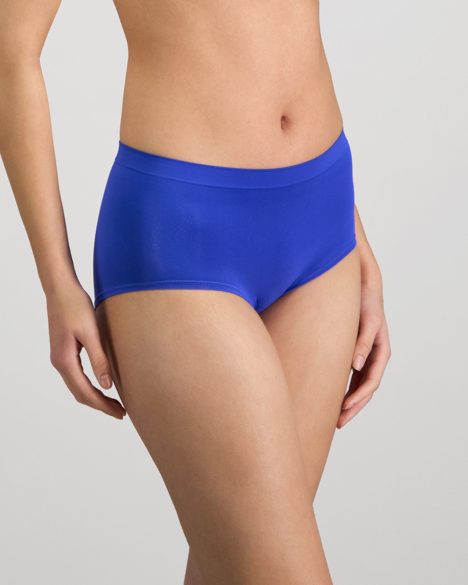 Model wears Seamless Soft Full Brief in DAZZLING BLUE. On body side view