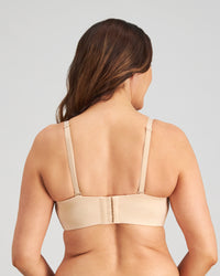 Model wears Bendon Bare Non Padded Strapless Bra in LATTE. On body back view