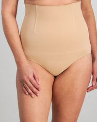 Model wears Bamboo Bodywear High Waisted Brief in CARAMEL. On body front view