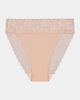 Model wears Lace Trim High Cut Brief in LATTE. On body front view