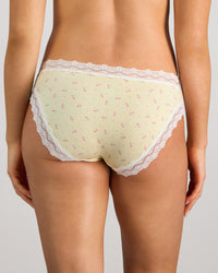 Model wears Daily Micro Bikini in TRANSPARENT YELLOW. On body back view