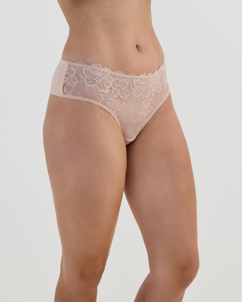 Model wears Lacey Brazilian in LATTE. On body side view