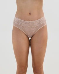 Model wears Lacey Brazilian in LATTE. On body front view