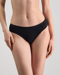 Model wears Body Cotton Bikini in BLACK. On body front view