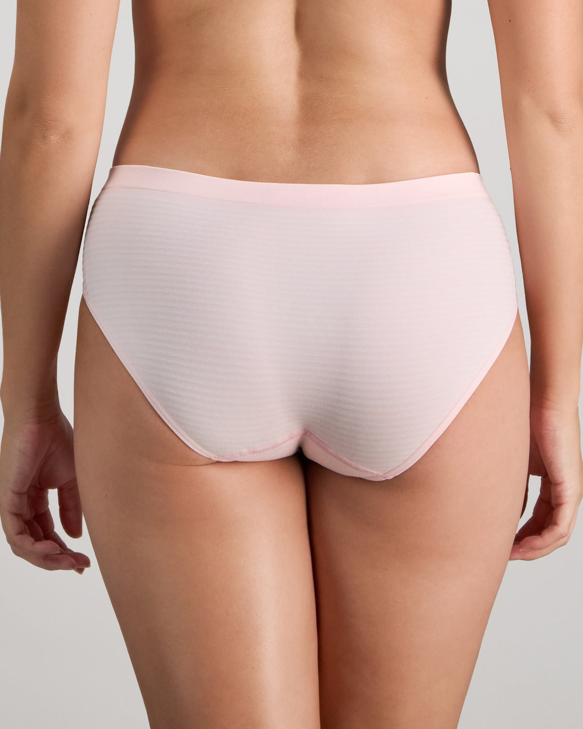 Model wears Simply Seamless Boyshort in ICY PINK/WHITE STRIPE. On body back view