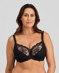 Model wears Mesmerise Underwire Bra in BLACK. On body front view
