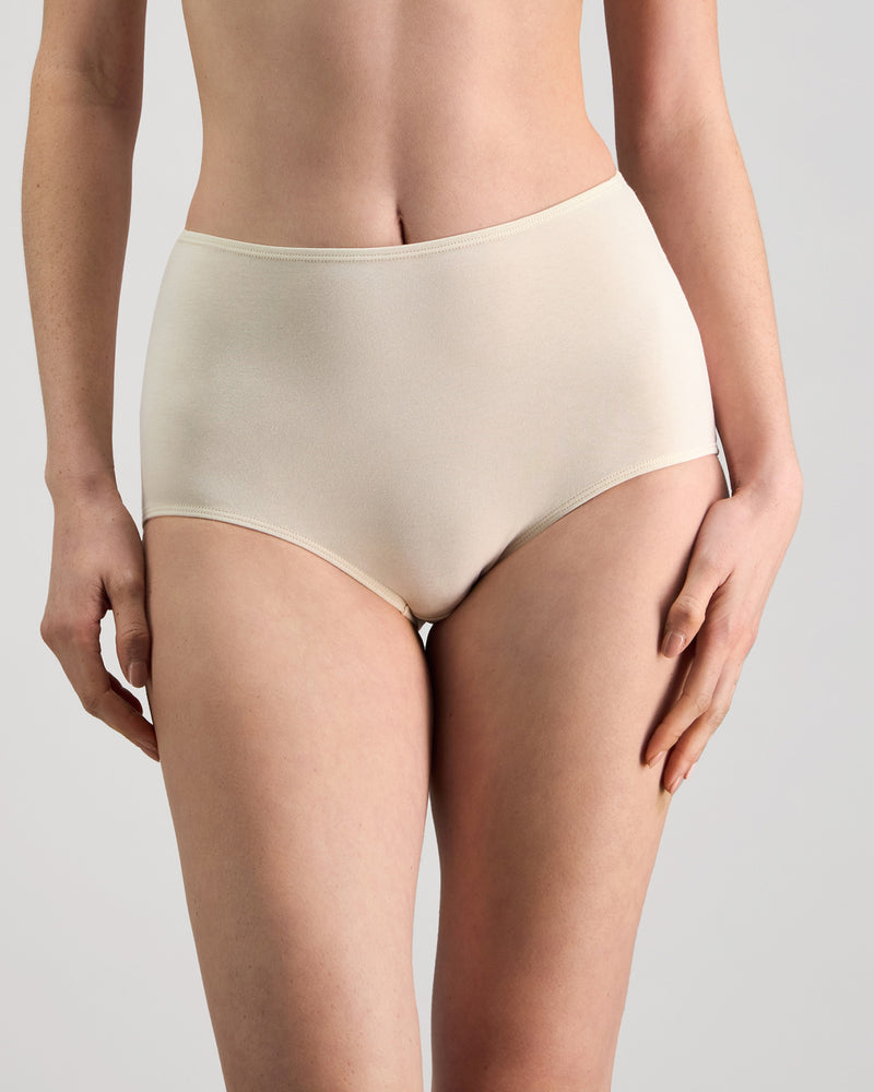 Model wears Freestyle Full Brief in CHAMPAGNE. On body front view