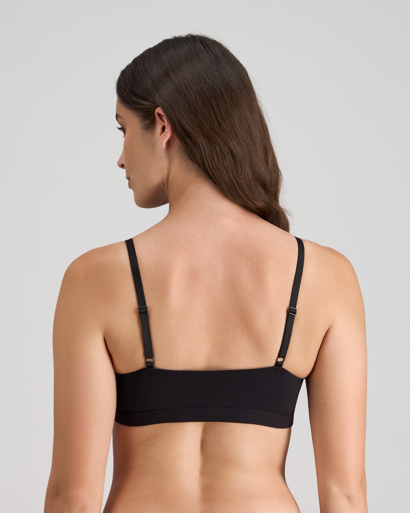 Model wears Extra-Ordinary Crop Top in BLACK. On body back view