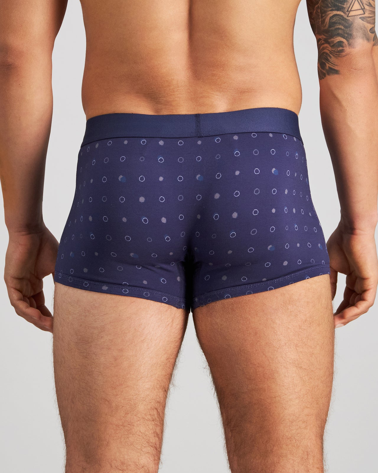 Model wears Retros Print Mens Trunk in INKY SPOT PRINT. On body back view