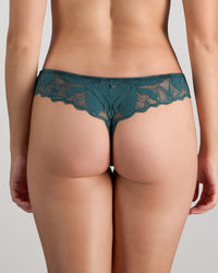 Model wears Margot Estelle Thong in MEDITERRANEA. On body back view
