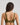 Model wears Bendon Breathe Contour Bra in DARK OLIVE/PINK. On body back view