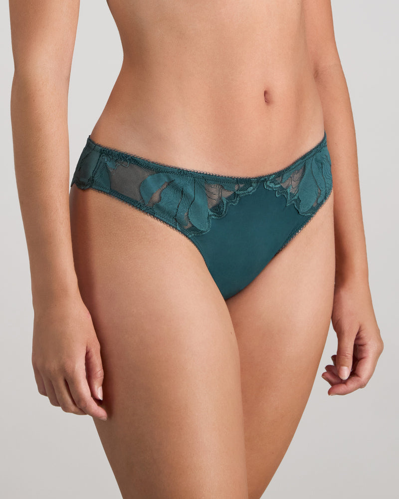 Model wears Margot Estelle Thong in MEDITERRANEA. On body side view