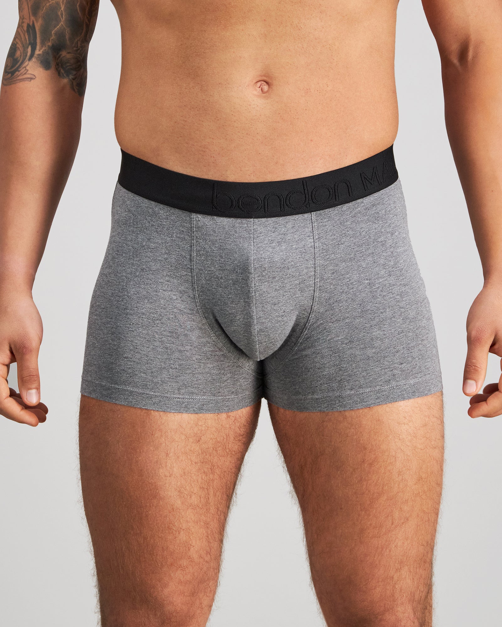 Model wears Everyday Essential Mens Trunk in GREY MARL. On body front view