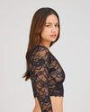 Model wears My Fit Lace Long Sleeve Top in BLACK. On body side view