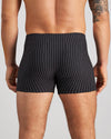 Model wears Cotton Stretch Mens Trunk in BLACK PINSTRIPE. On body back view