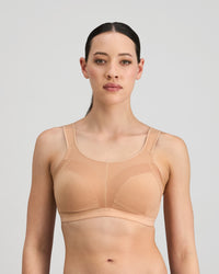 Model wears Stamina Wire Free Bra in LATTE. On body front view