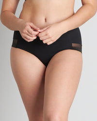 Model wears Comfit Collection Midi in BLACK. On body front view
