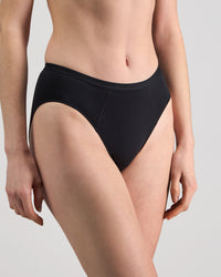 Model wears Body Cotton High Cut Brief in BLACK. On body side view