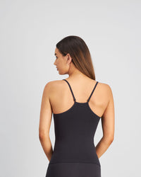 Model wears Simply Seamless Camisole in BLACK. On body back view