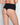 Model wears Bamboo Bodywear Thong in BLACK. On body back view