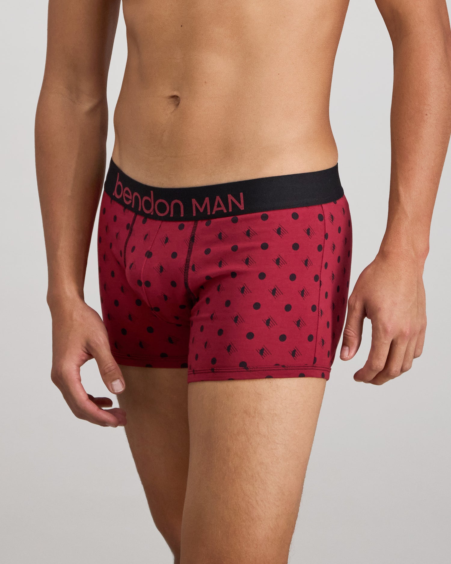 Model wears Retros Print Mens Trunk in DISRUPTED SPOT PRINT. On body side view