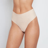 Model wears No Show Thong in LATTE. On body front view