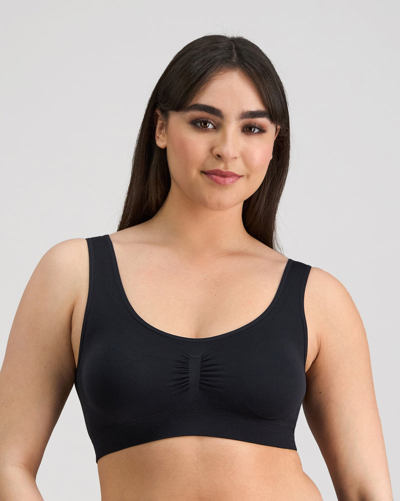 Model wears Bendon Essentials Crop Top in BLACK. On body front view