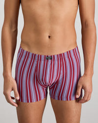 Model wears Cotton Stretch Mens Trunk in TIBETAN RED STRIPE. On body front view