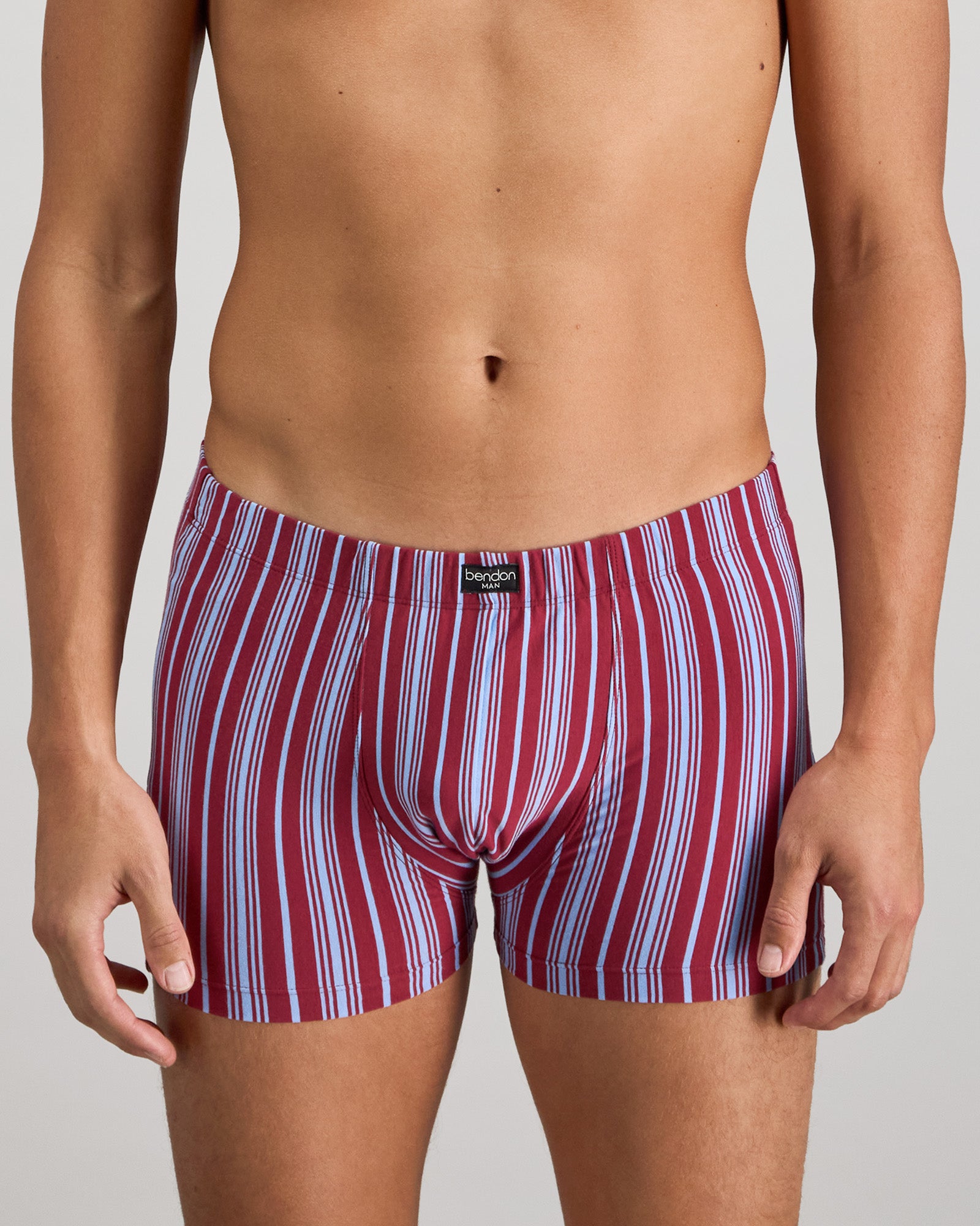 Model wears Cotton Stretch Mens Trunk in TIBETAN RED STRIPE. On body front view
