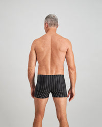 Model wears Cotton Stretch Mens Trunk in BLACK WHITE. On body back view