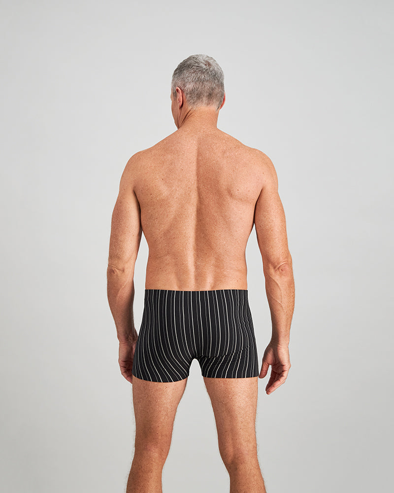 Model wears Cotton Stretch Mens Trunk in BLACK WHITE. On body back view