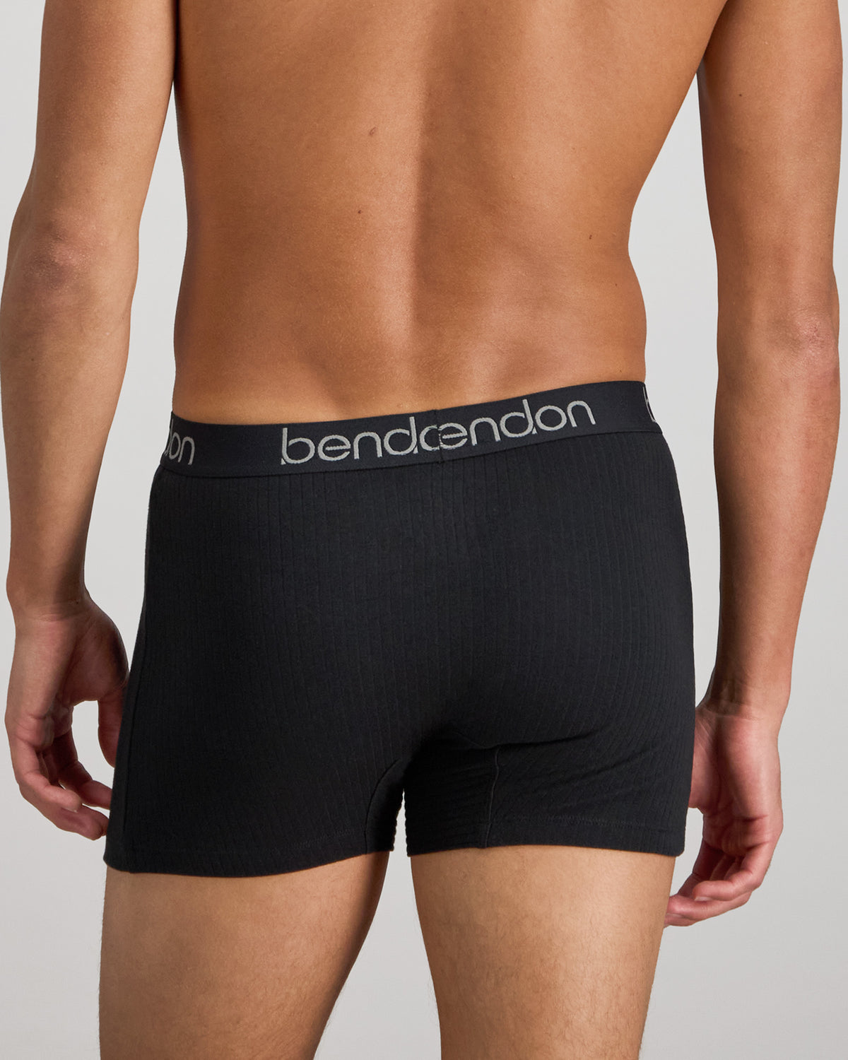 Model wears Cotton Texture Mens Trunk in BLACK. On body back view