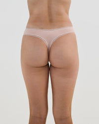 Model wears Stretch Cotton Thong in LATTE. On body back view