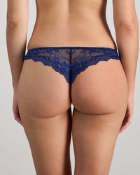 Model wears My Fit Lace Thong in Medieval Blue. On body back view