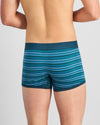 Model wears Bold Stripe Mens Trunk in DEEP TEAL/DEEP LAKE. On body back view