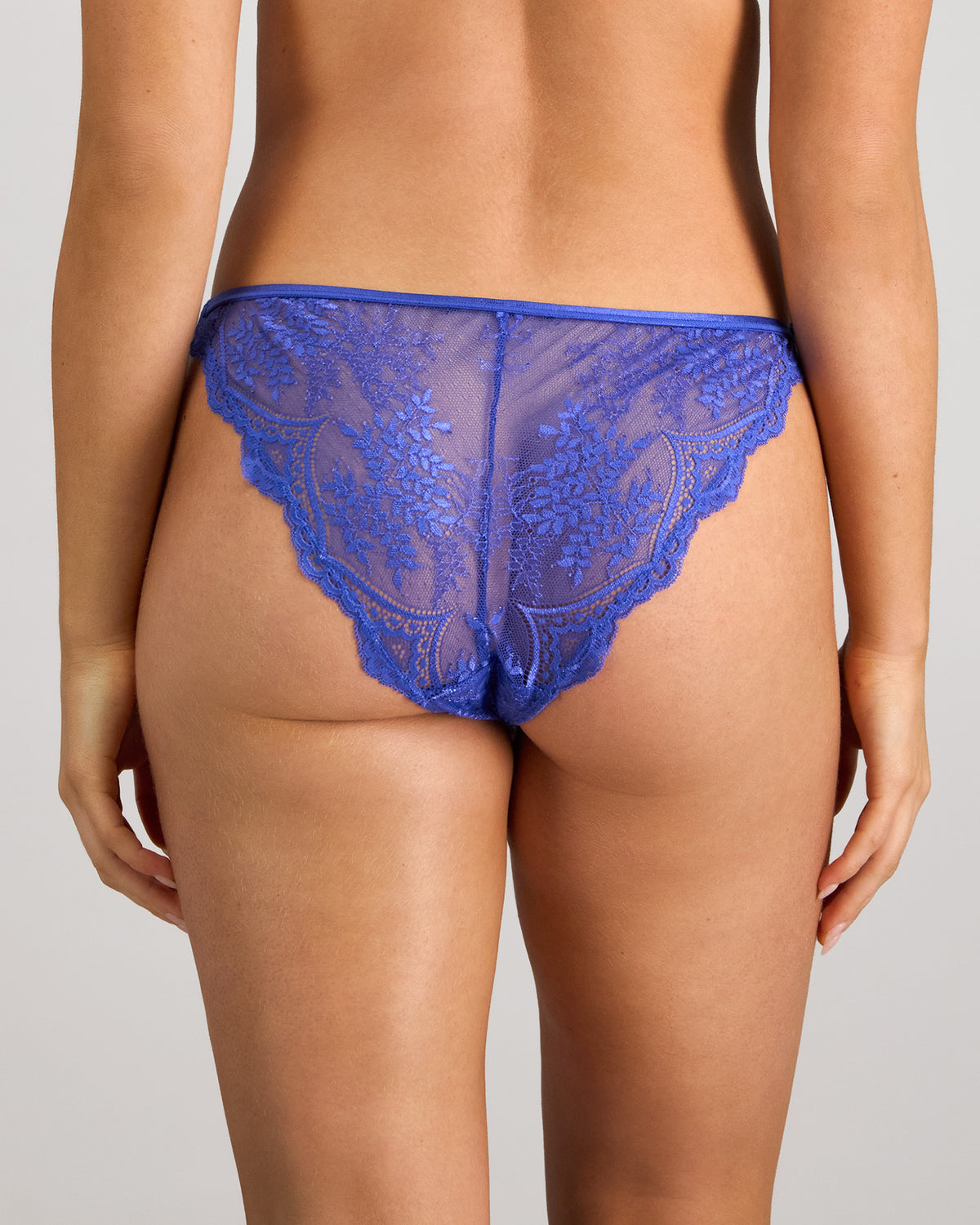 Model wears Midnight Muse Tanga in DAZZLING BLUE. On body back view