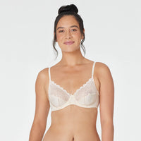 Model wears Yvette Underwire Bra in NATURAL. On body front view