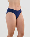 Model wears Seamless Soft Bikini in Medieval Blue. On body side view