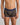 Model wears Bold Stripe Mens Trunk in BLACK/OAK BUFF STRIPE. On body front view