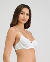 Model wears Body Cocoon Underwire Bra in WHITE. On body side view