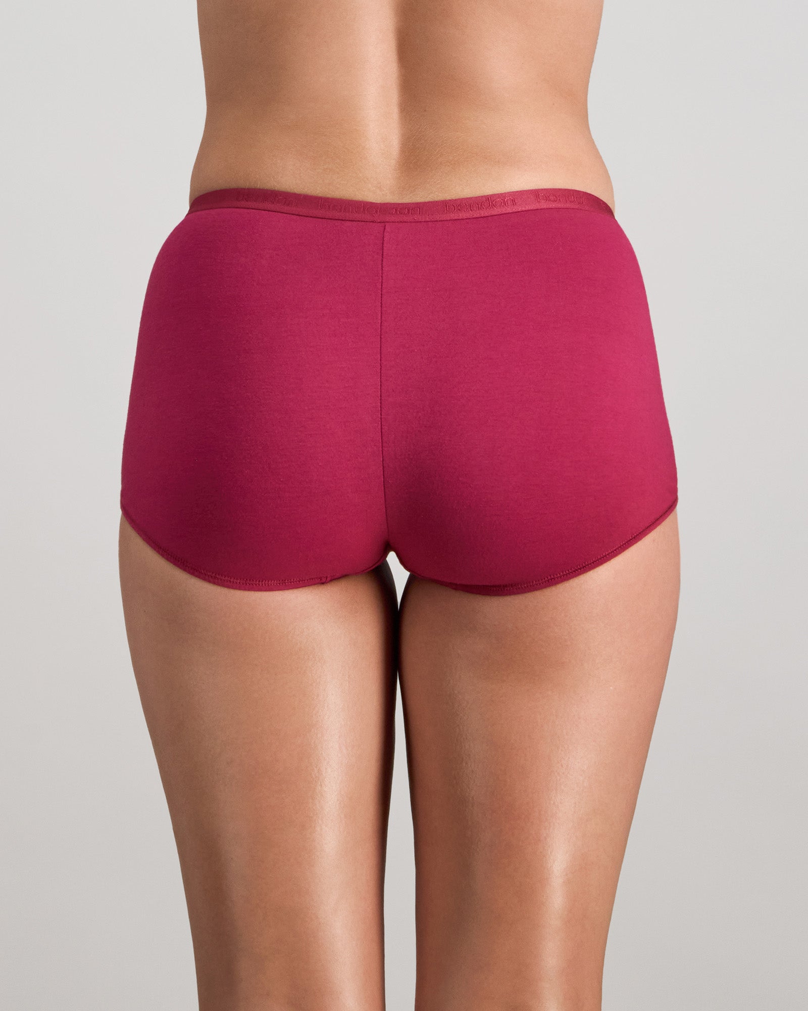 Model wears Body Cotton Full Brief in BEAUJOLAIS. On body back view
