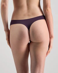 Model wears Au Naturel Thong in PLUM PERFECT. On body back view