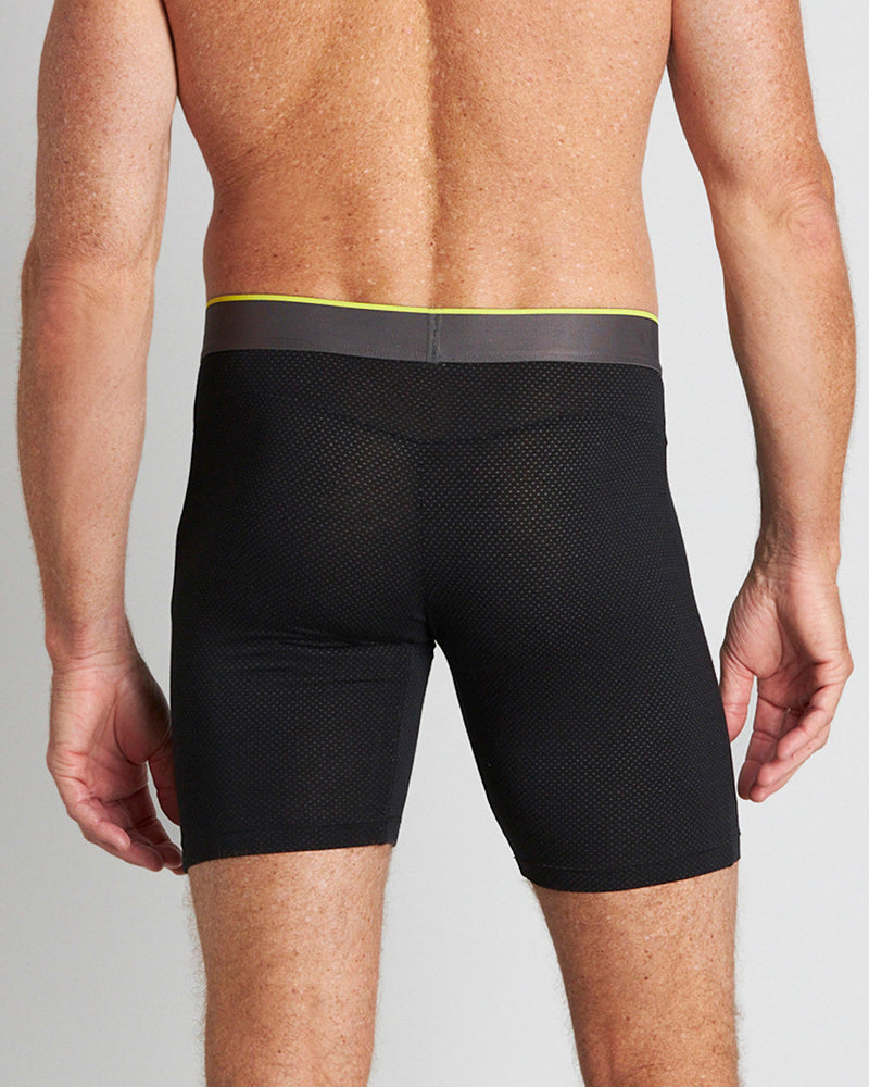 Model wears Everyday Active Mens Long Trunk in BLACK. On body back view