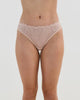 Model wears All Lacey Thong in LATTE. On body front view