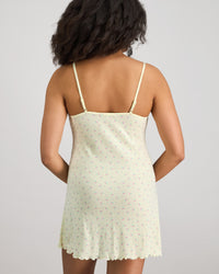 Model wears Smoothie Chemise in TRANSPARENT YELLOW. On body back view