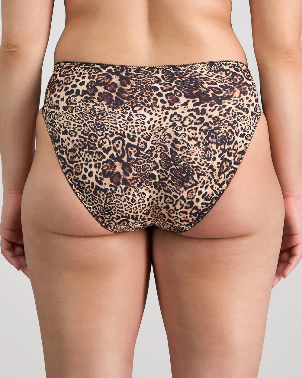 Model wears Violet Floral High Cut Brief in MYTHOS ANIMAL PRINT. On body back view