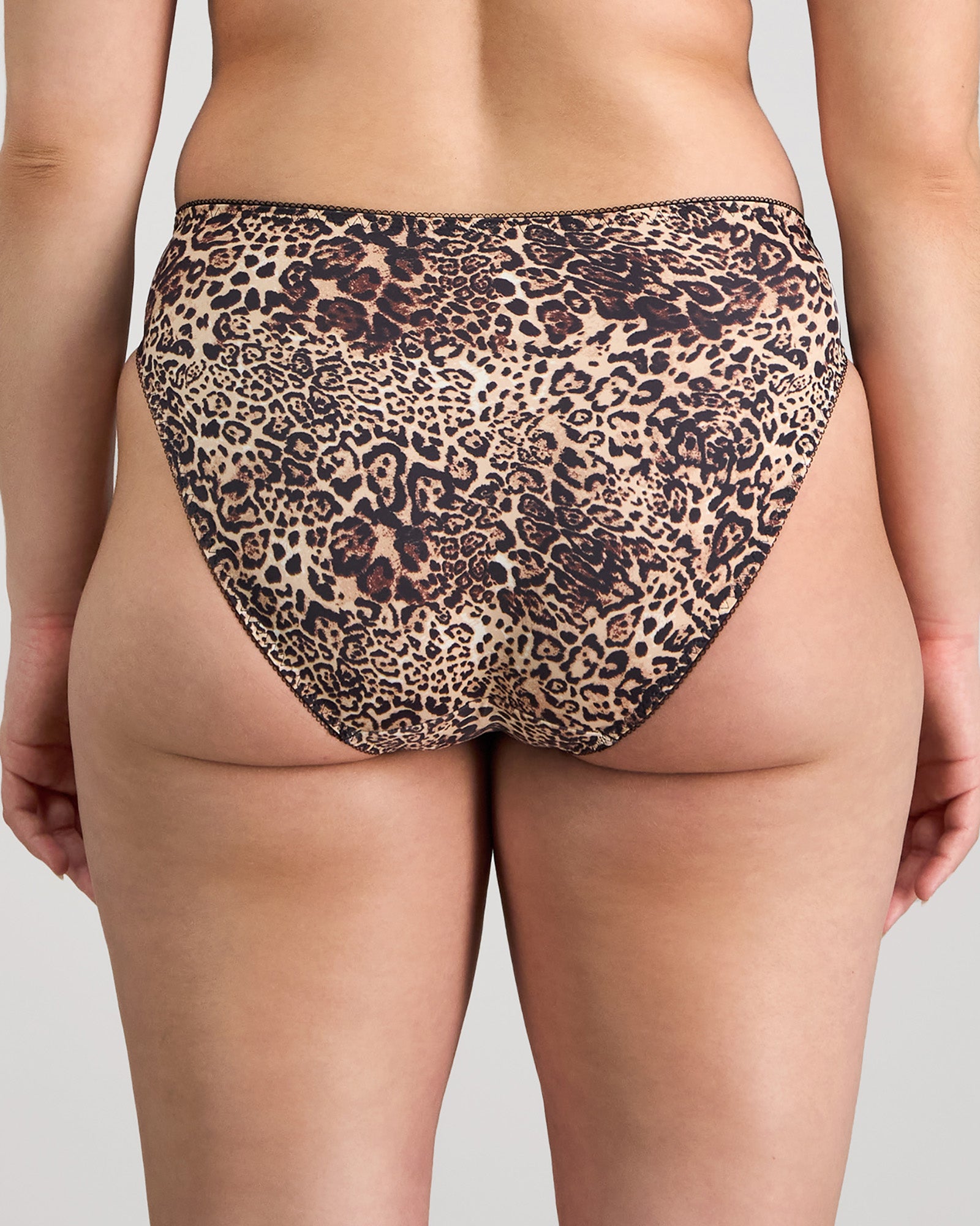Model wears Violet Floral High Cut Brief in MYTHOS ANIMAL PRINT. On body back view