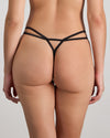 Model wears Adaline Thong in BLACK FLORAL PRINT. On body back view