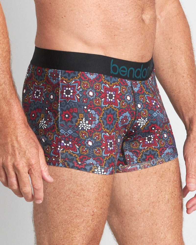 Model wears Retros Print Mens Trunk in GLOBAL TILE PRINT. On body side view