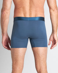 Model wears Bamboo Mens Trunk in BLUE WING TEAL. On body back view